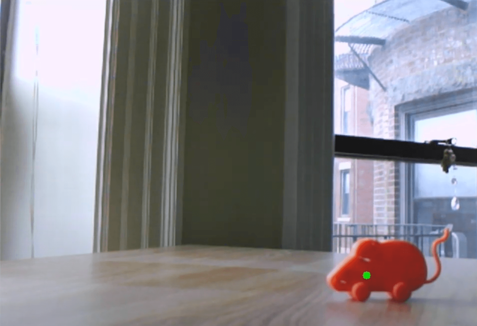 Webcam footage of model mouse being tracked by a green dot in OpenCV